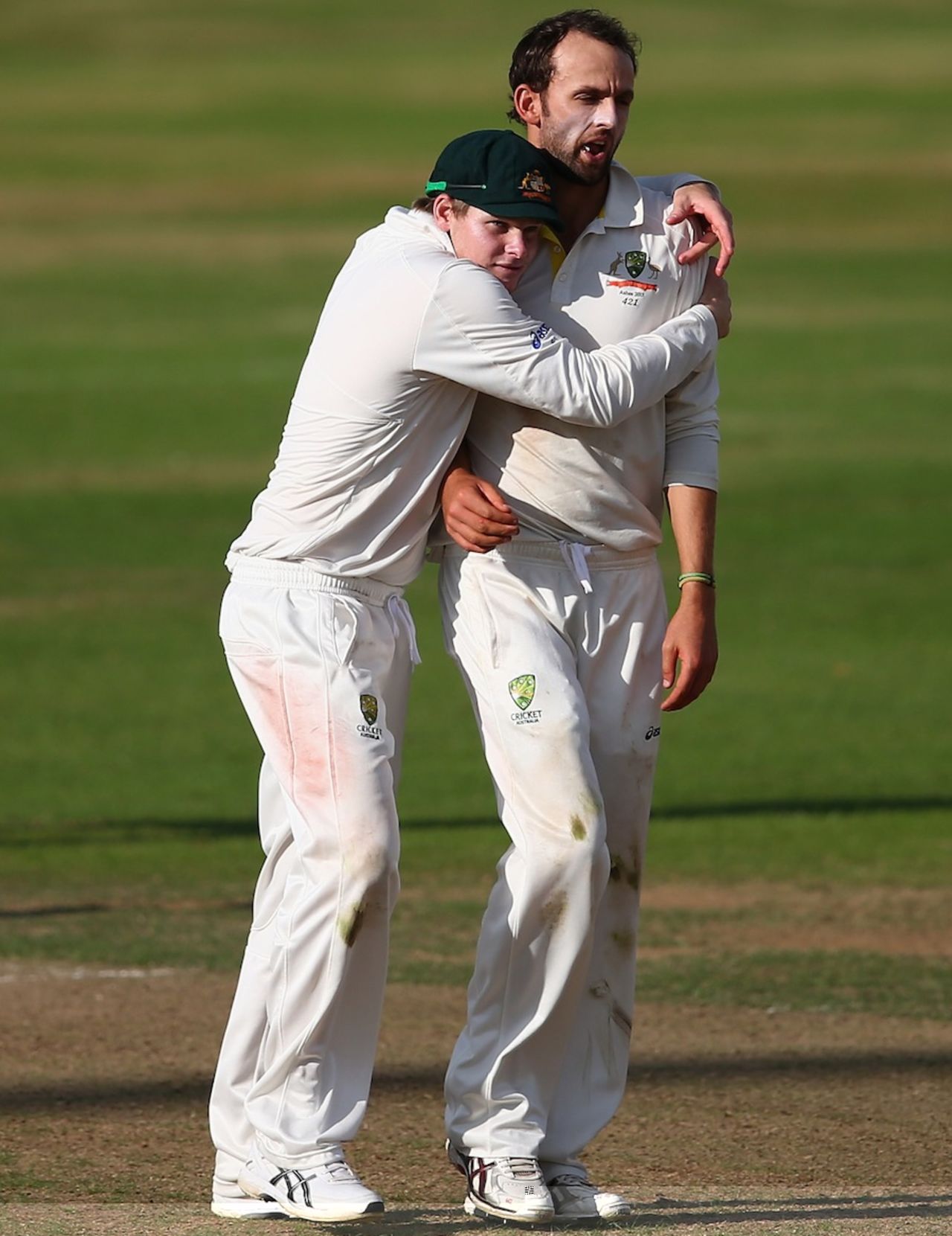 Nathan Lyon gets a hug from Steven Smith after claiming a wicket, England Lions v Australians, day 1, County Ground, Northampton, August 16, 2013