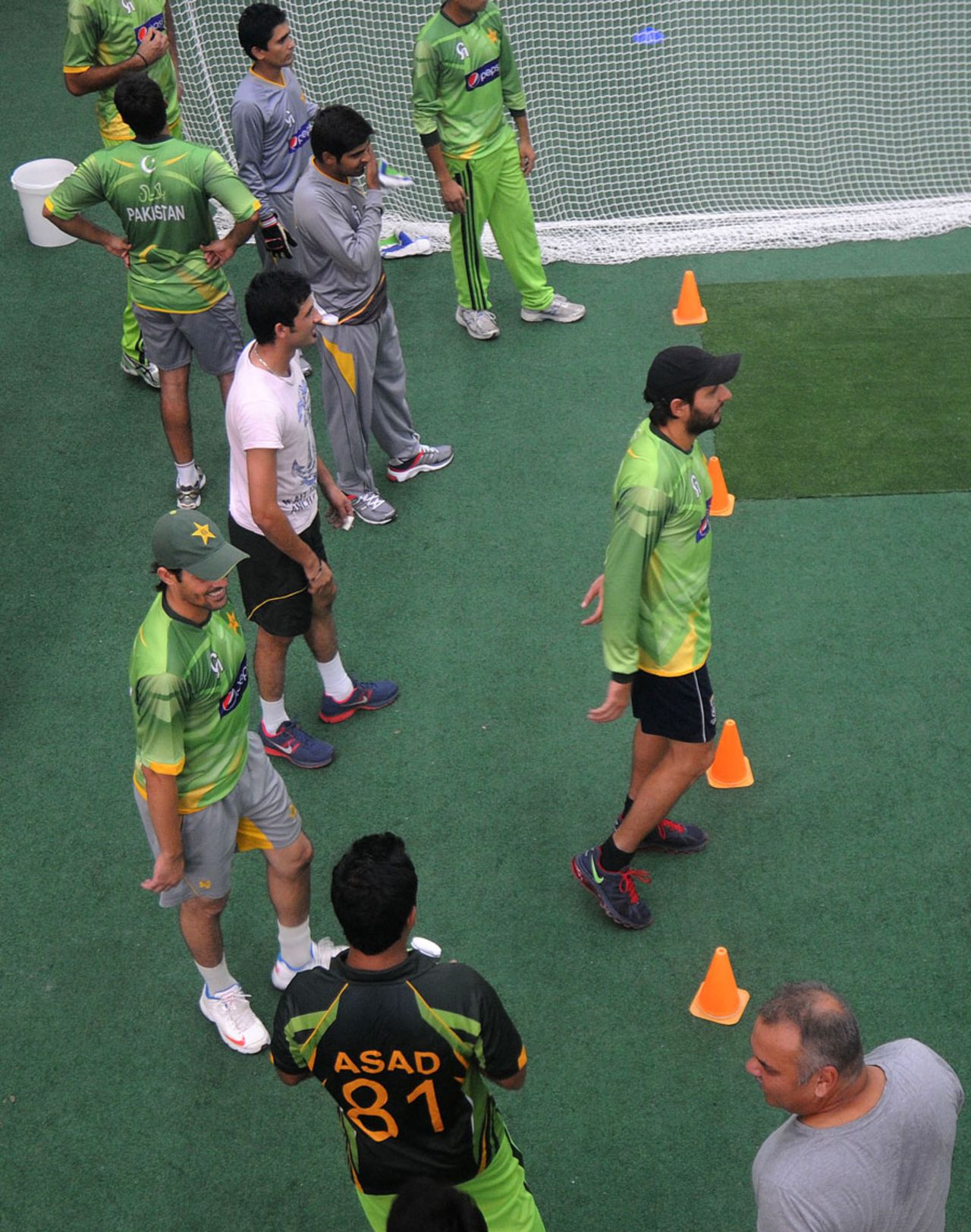 Pakistan players watch their team-mates practice, Lahore, August 18, 2013