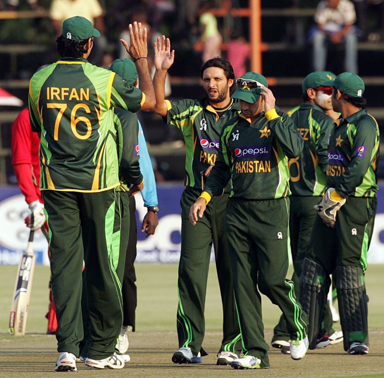 Shahid Afridi and his team-mates celebrate a wicket, Zimbabwe v Pakistan, 1st T20, Harare, August 23, 2013