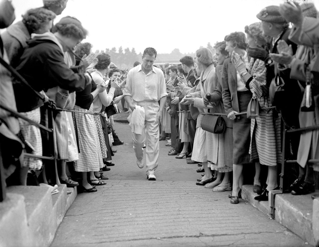 Jim Laker walks back to the pavilion applauded by fans for his 11-wicket match-haul, England v Australia, 3rd Test, Headingley, 5th day, July 17, 1956