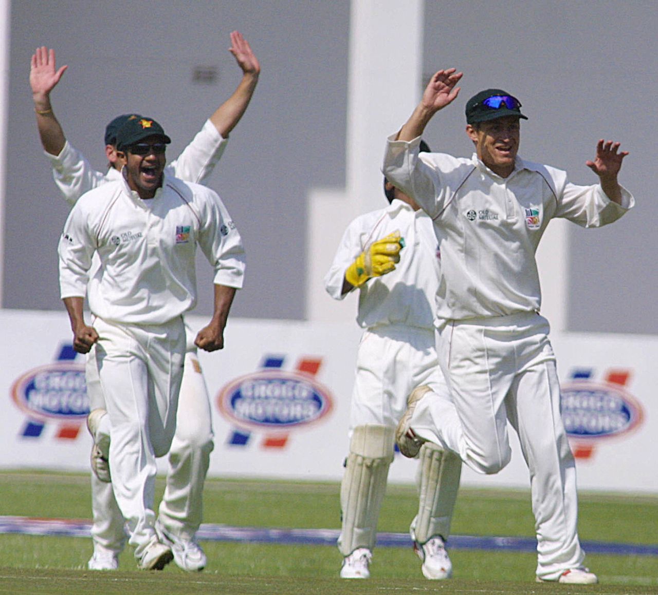 Dion Ebrahim and Trevor Gripper celebrate the dismissal of Hamish Marshall, Zimbabwe v New Zealand, 1st Test, Harare, 1st day, August 7, 2005