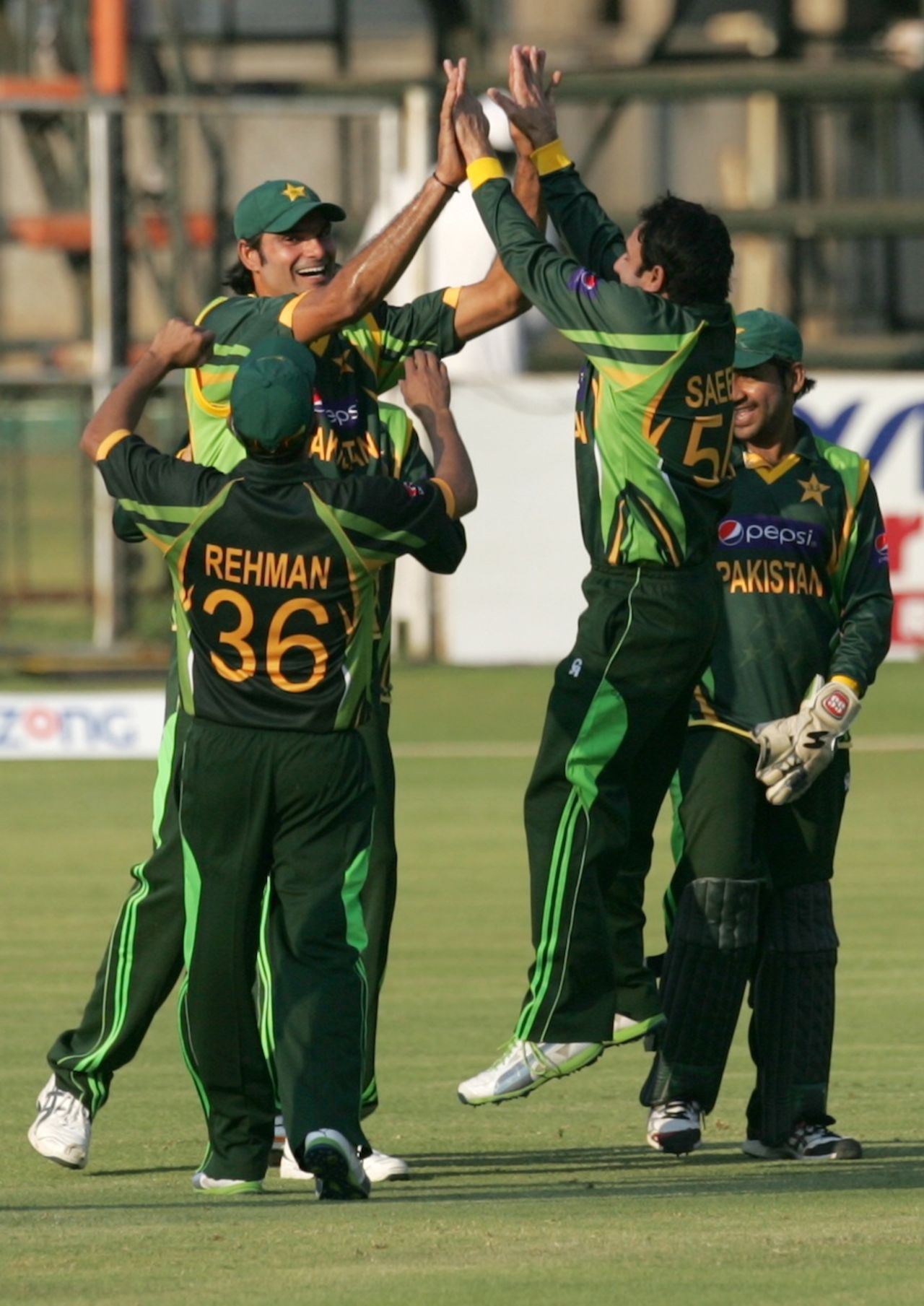 Mohammad Irfan and Saeed Ajmal celebrate a wicket with team-mates, Zimbabwe v Pakistan, 2nd ODI, Harare, August 29, 2013