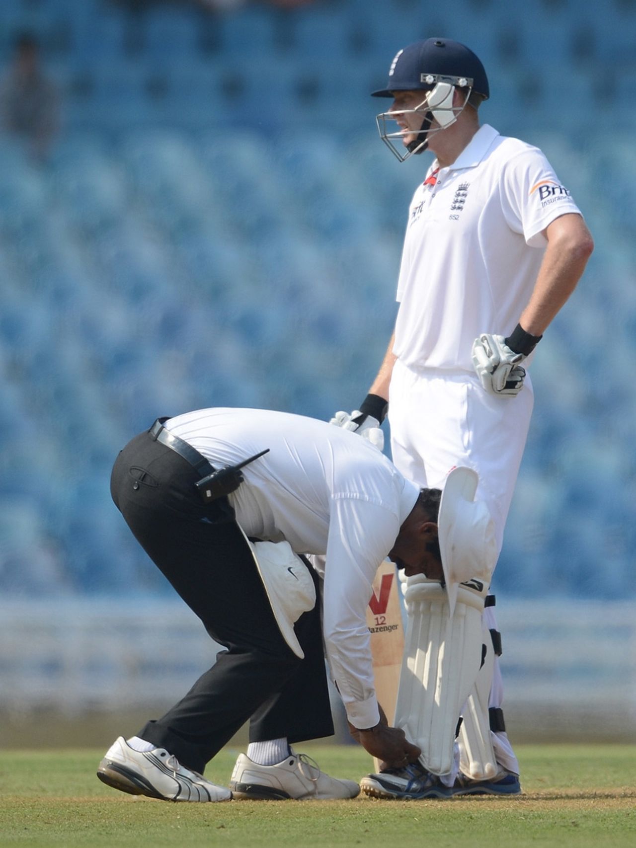 The umpire helps Jonny Bairstow with his shoelaces, Mumbai A v England, DY Patil Stadium, Navi Mumbai, November 3, 2012