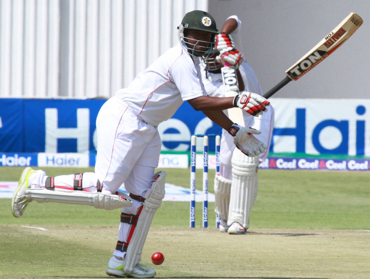 Tino Mawoyo skips to the side of a Vusi Sibanda straight drive, Zimbabwe v Pakistan, 1st Test, Harare, 2nd day, September 4, 2013