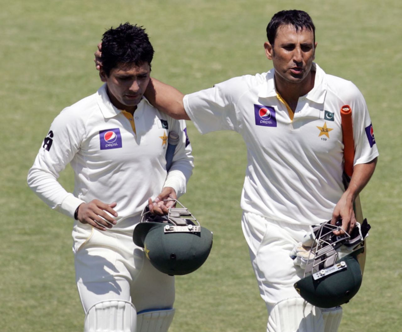 Younis Khan and Adnan Akmal walk off the pitch for the lunch break, Zimbabwe v Pakistan, 1st Test, 4th day, Harare, September 6, 2013