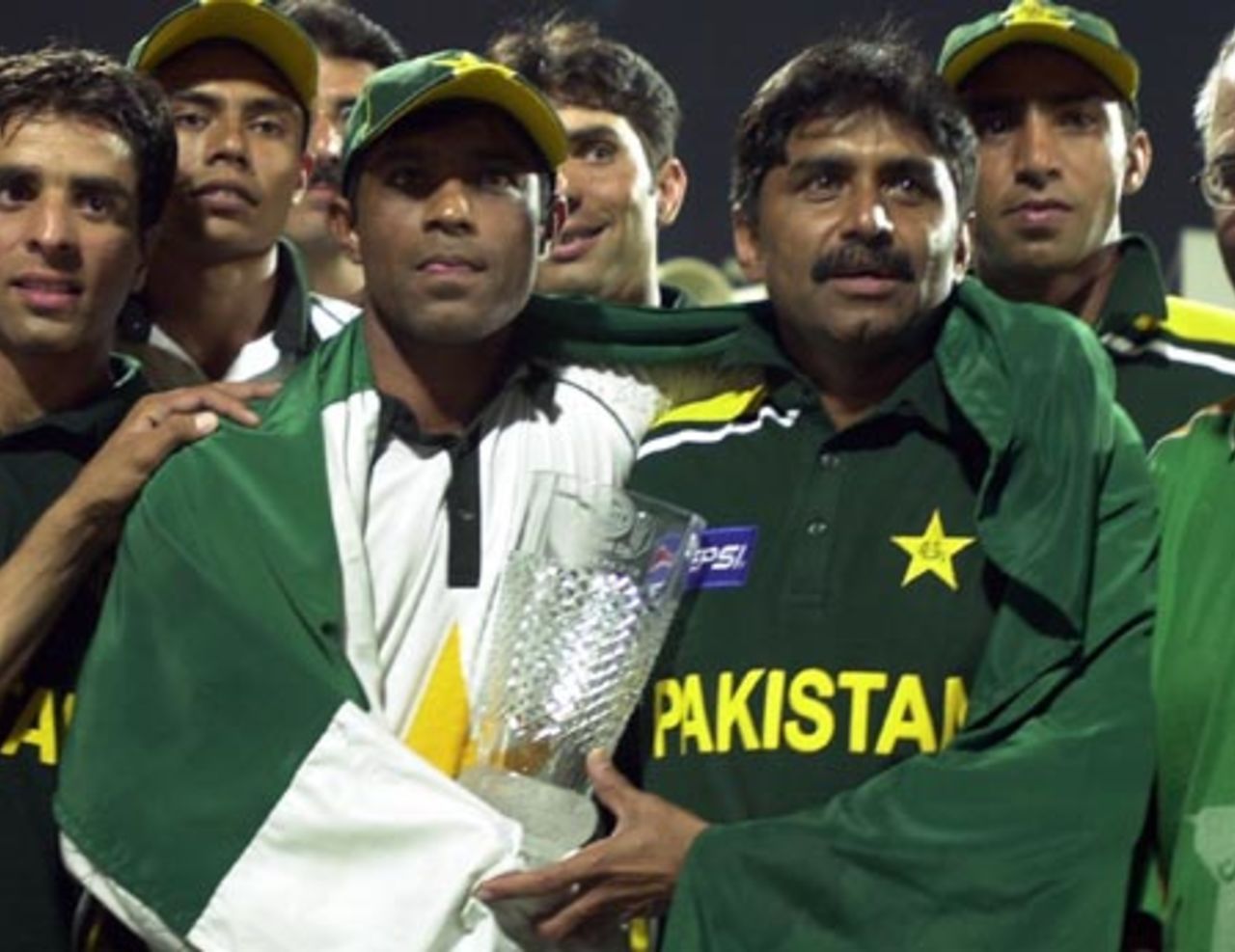 Pakistani Cricket team captain Rashid Latif (L) and coach Javed Miandad hold the Sharjah Cup 2003 togather after the final match after winning the Four Nation Sharjah Cricket Tournament, 10 April 2003