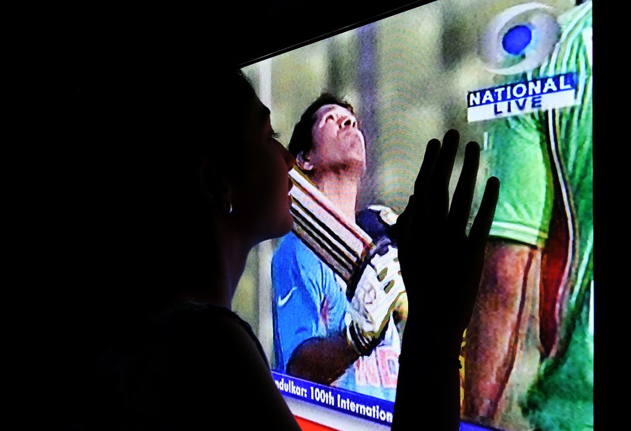 A fan watches Sachin Tendulkar on television, Delhi, March 16, 2012