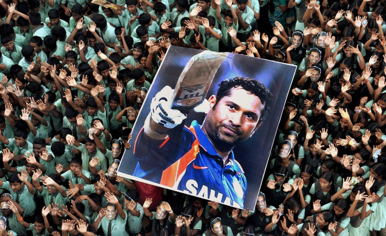 School children hold up a giant poster of Sachin Tendulkar on the occasion of his 100th international century, Chennai, March 16, 2012
