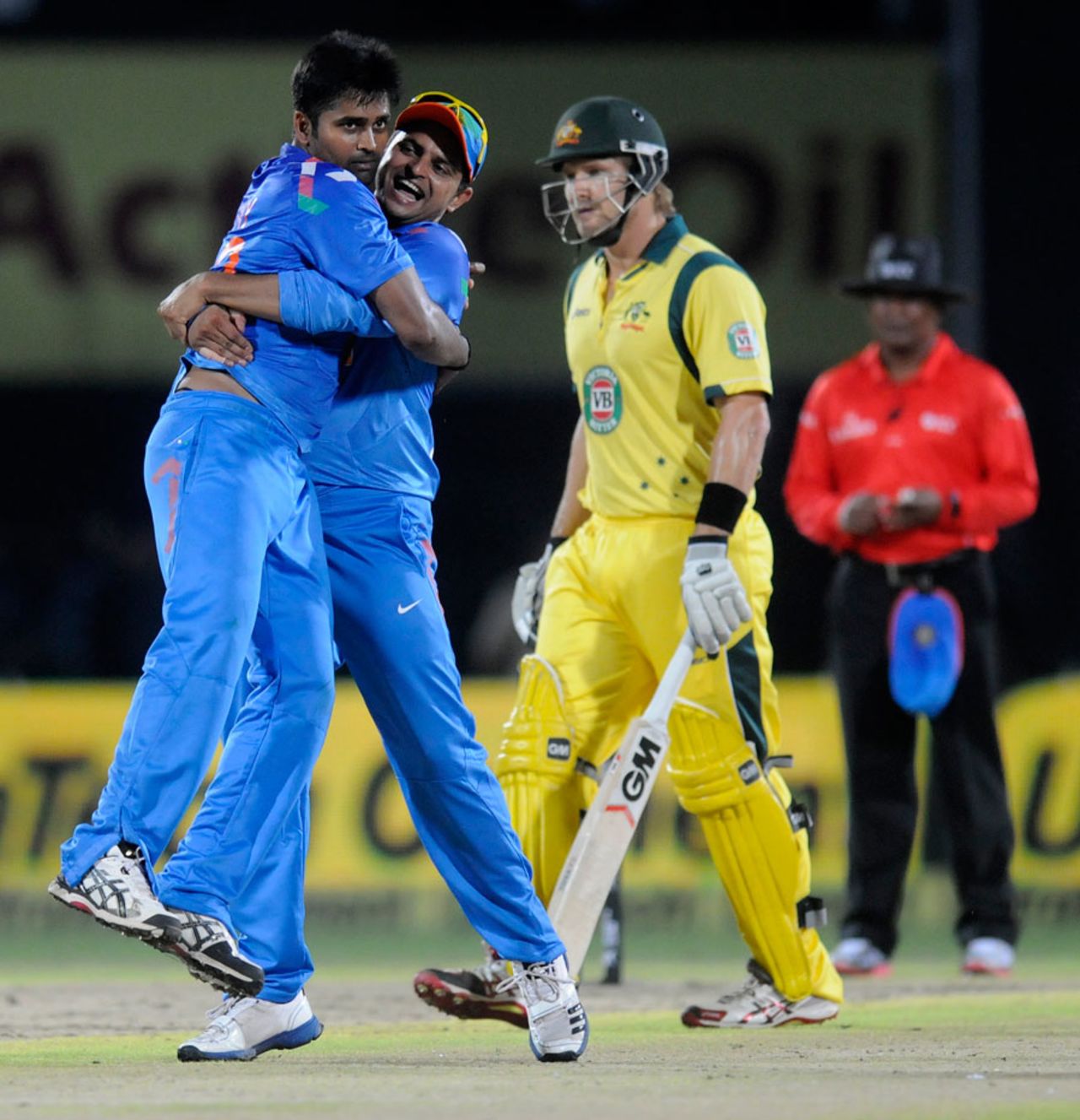 Suresh Raina hugs Vinay Kumar after the latter dismissed Shane Watson, India v Australia, one-off T20, Rajkot, October 10, 2013