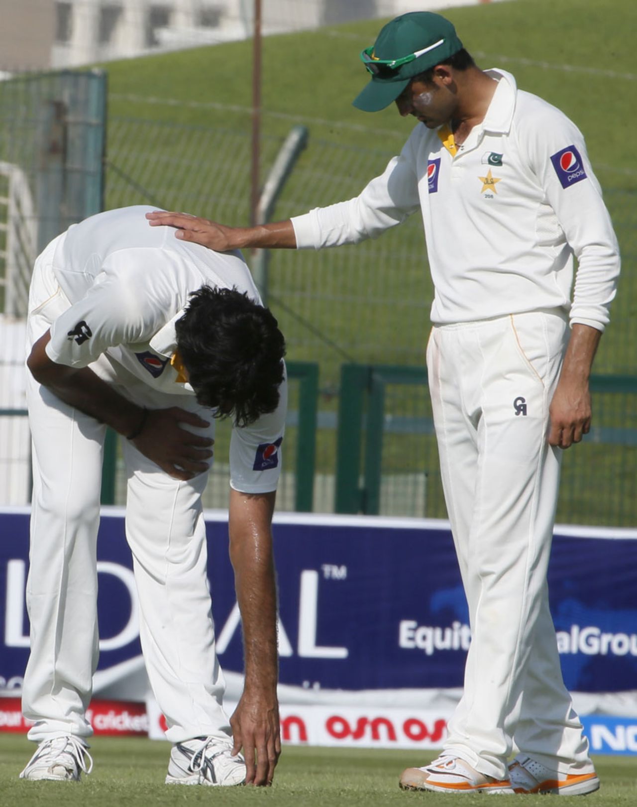 Mohammad Irfan performs some stretching exercises after pulling up with a niggle, Pakistan v South Africa, 1st Test, Abu Dhabi, 1st day, October 14, 2013