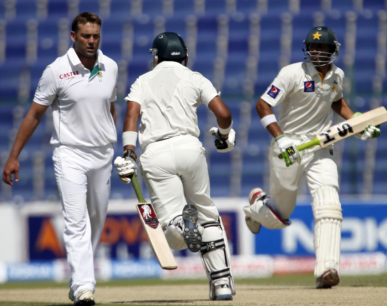 Jacques Kallis walks back to his mark while Khurram Manzoor and Shan Masood take a single, Pakistan v South Africa, 1st Test, Abu Dhabi, 2nd day, October 15, 2013