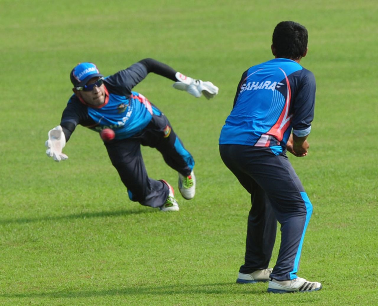 Mushfiqur Rahim dives for a catch during a training session, Dhaka, October 20, 2013