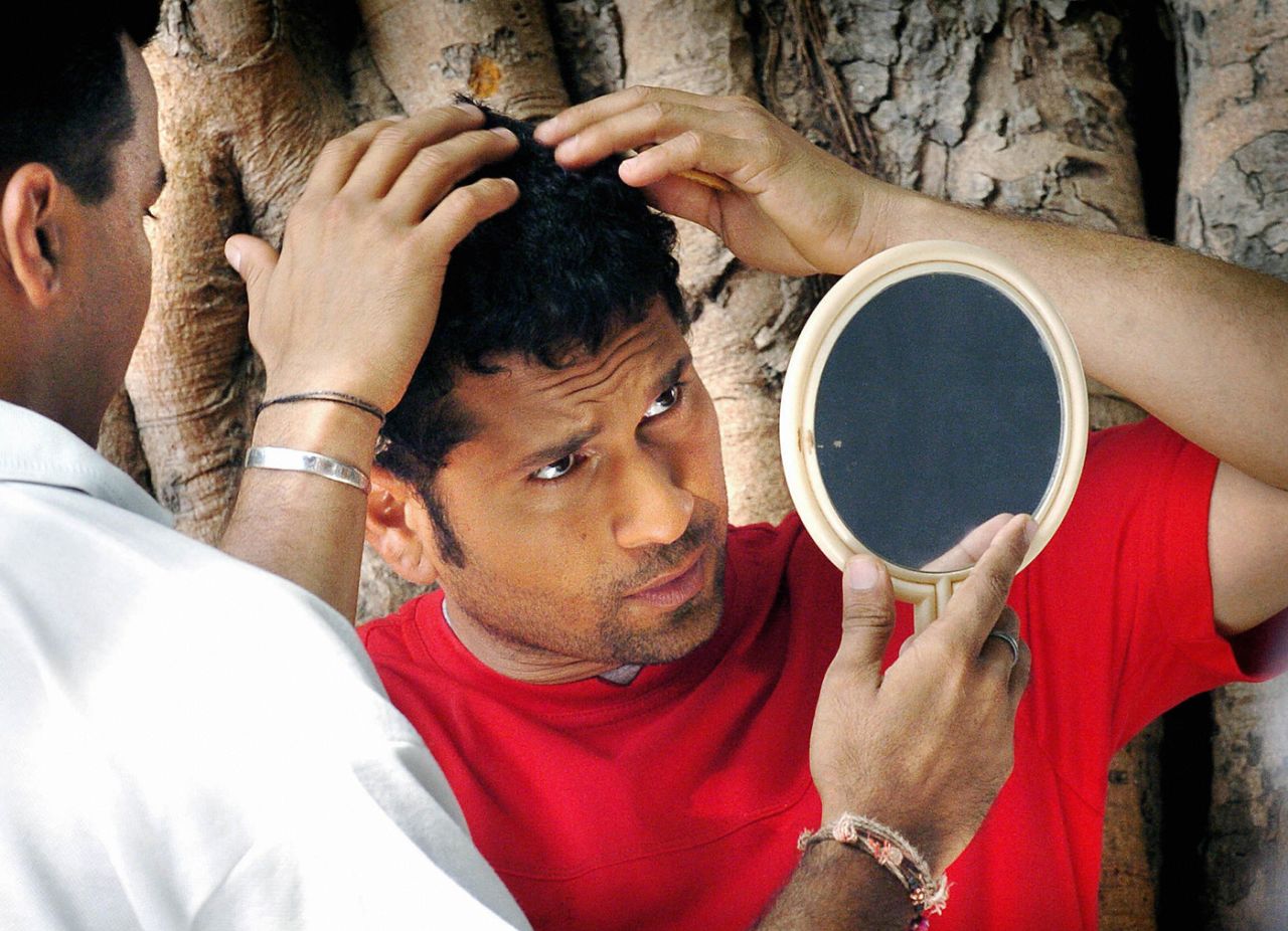 Sachin Tendulkar checks his hair in a mirror during a commercial shoot, Mumbai, April 22, 2004