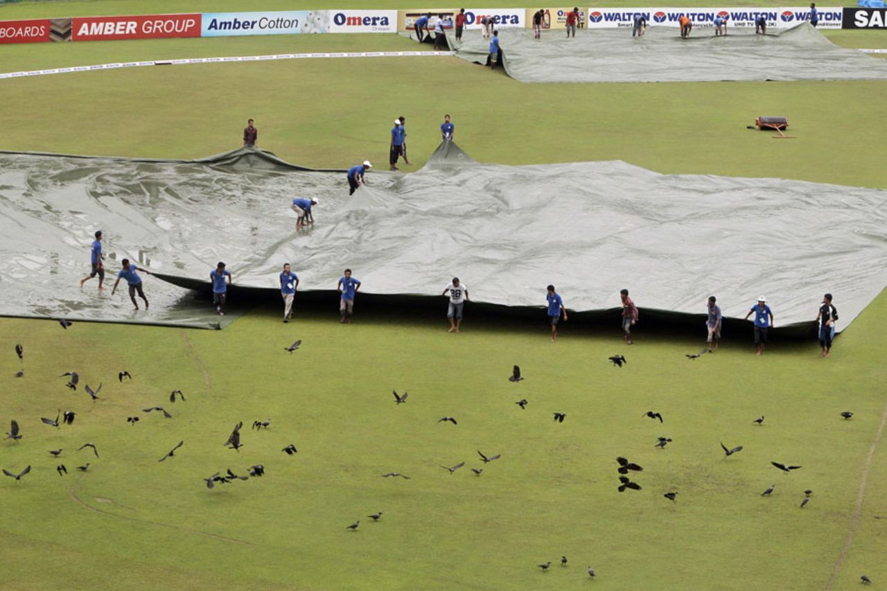 Bangladesh's ground staff pull covers on the ground, Bangladesh v New Zealand, 2nd Test, 5th day, Mirpur, October 25, 2013