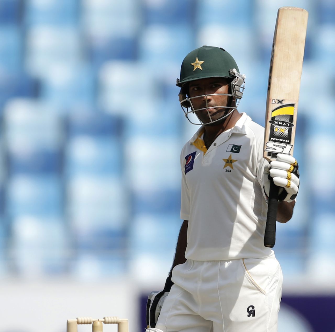Asad Shafiq raises his bat after his half-century, Pakistan v South Africa, 2nd Test, Dubai, 4th day, October 26, 2013
