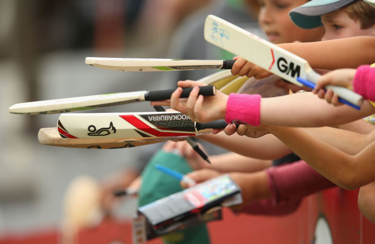 Fans line up bats for autographs on the sidelines of the Ryobi final, New South Wales v Queensland, Ryobi One Day Cup, final, North Sydney Oval, October 27, 2013