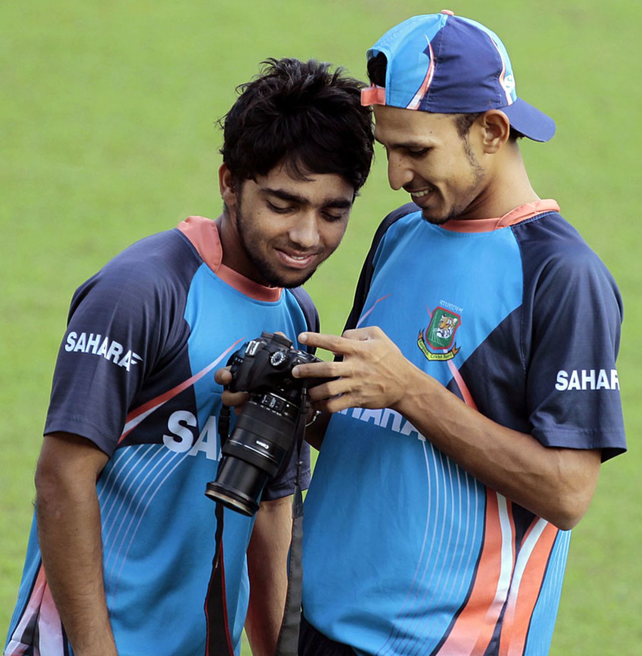 Mominul Haque and Nasir Hossain play around with a camera during training, Mirpur, October 28, 2013