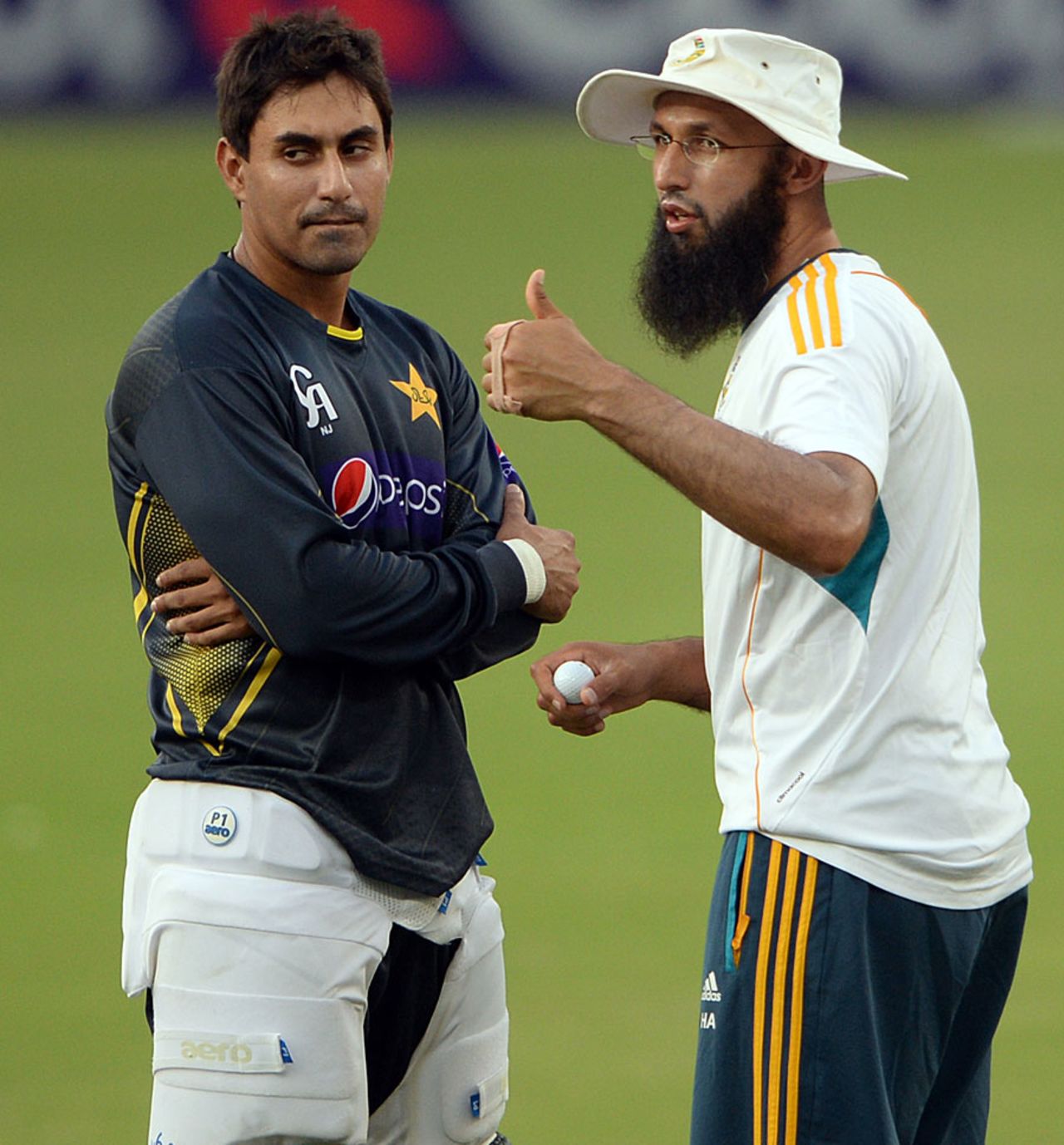 Nasir Jamshed and Hashim Amla have a chat during a nets session, Dubai, November 3, 2013