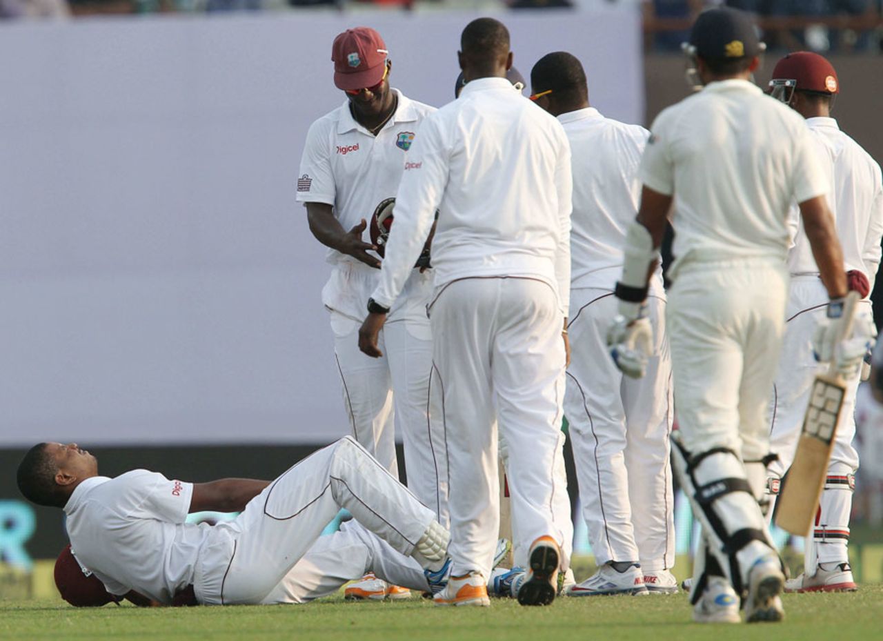 Kieran Powell writhes in pain as his team-mates assemble around him, India v West Indies, 1st Test, Kolkata, 1st day, November 6, 2013