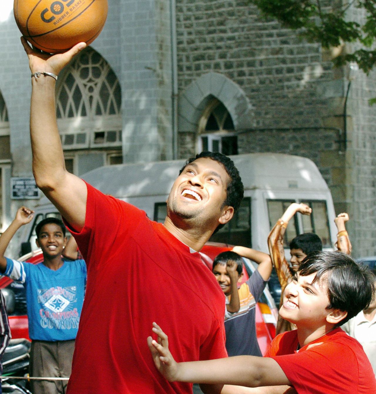 Sachin Tendulkar plays basketball with a youngster during a commercial shoot, Mumbai, April 22, 2004