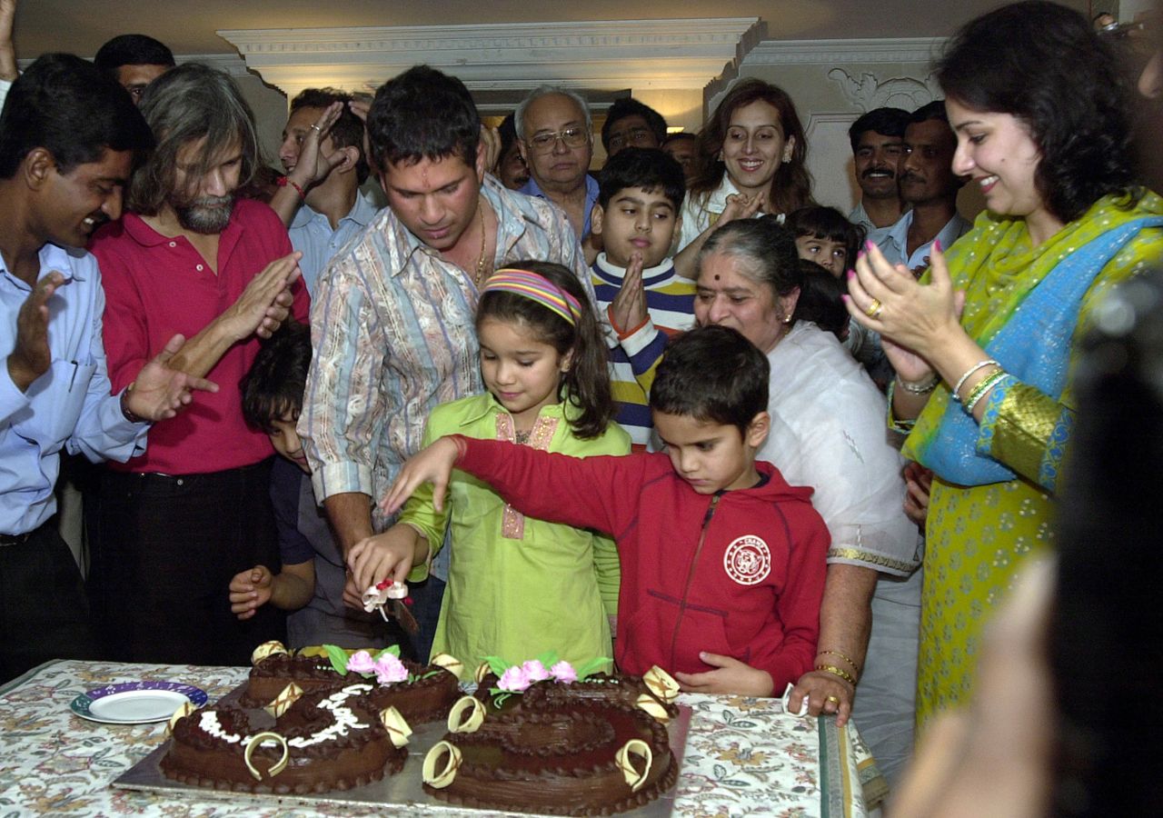 Sachin Tendulkar cuts a cake with his children during a function organised by his friends and family to celebrate his 35th Test century, Mumbai, December 14, 2005