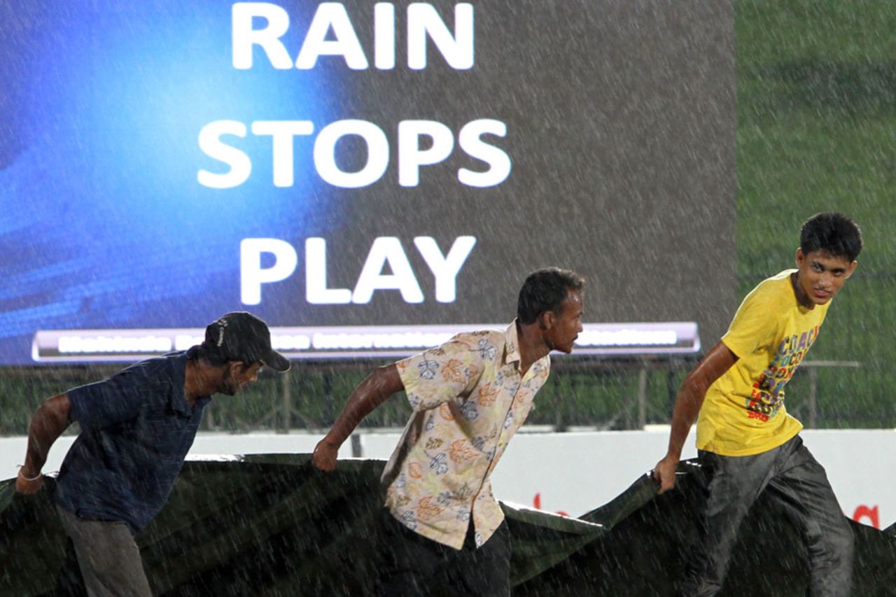 The groundstaff hurry to put the covers on, Sri Lanka v New Zealand, 1st ODI, Hambantota, November 10, 2013