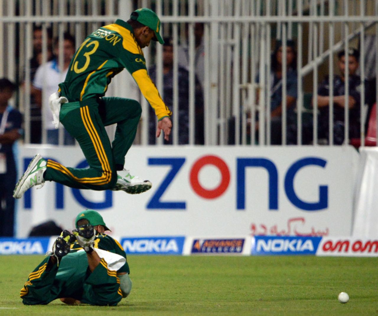 Robin Peterson leaps over a team-mate to stop a ball in the field, Pakistan v South Africa, 5th ODI, Sharjah, November 11, 2013