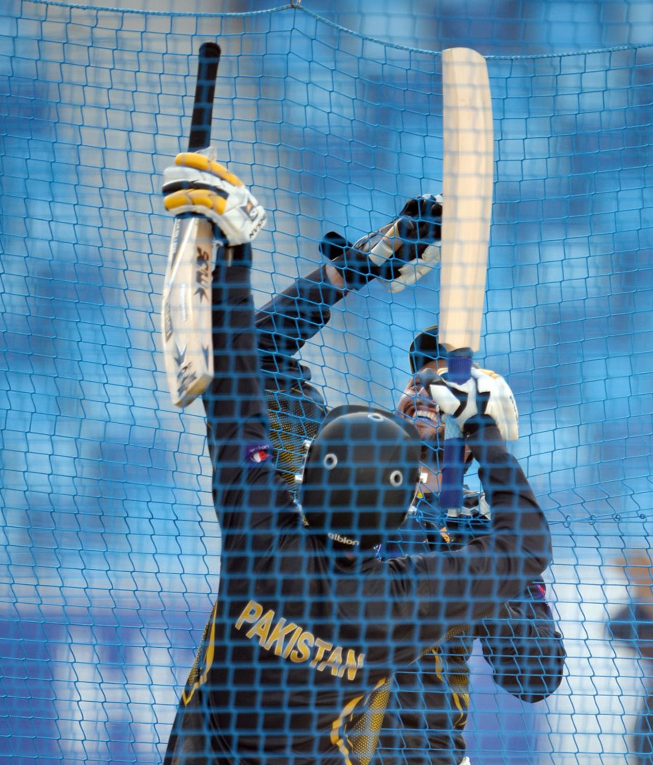 Ahmed Shehzad and Shahid Afridi exchange bats during a nets session, Dubai, November 12, 2013