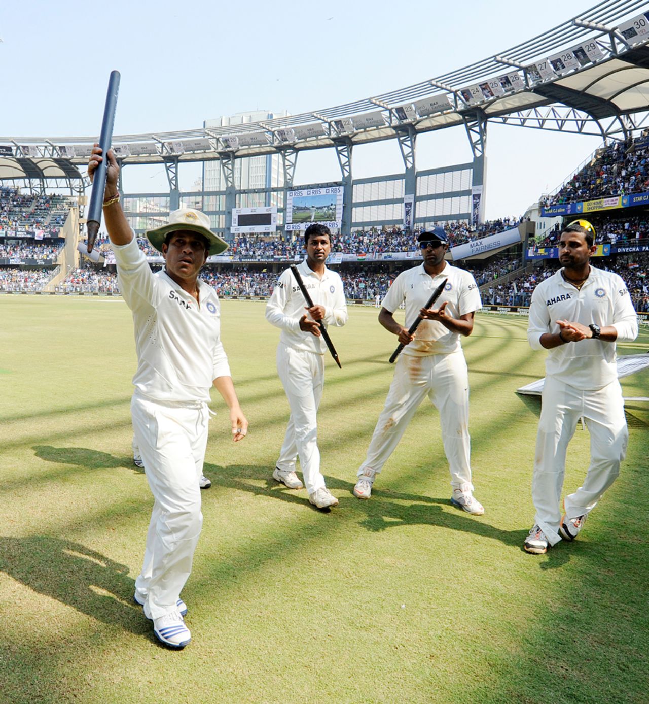 Sachin Tendulkar's team-mates clap him off the field after his final Test, India v West Indies, 2nd Test, Mumbai, 3rd day, November 16, 2013