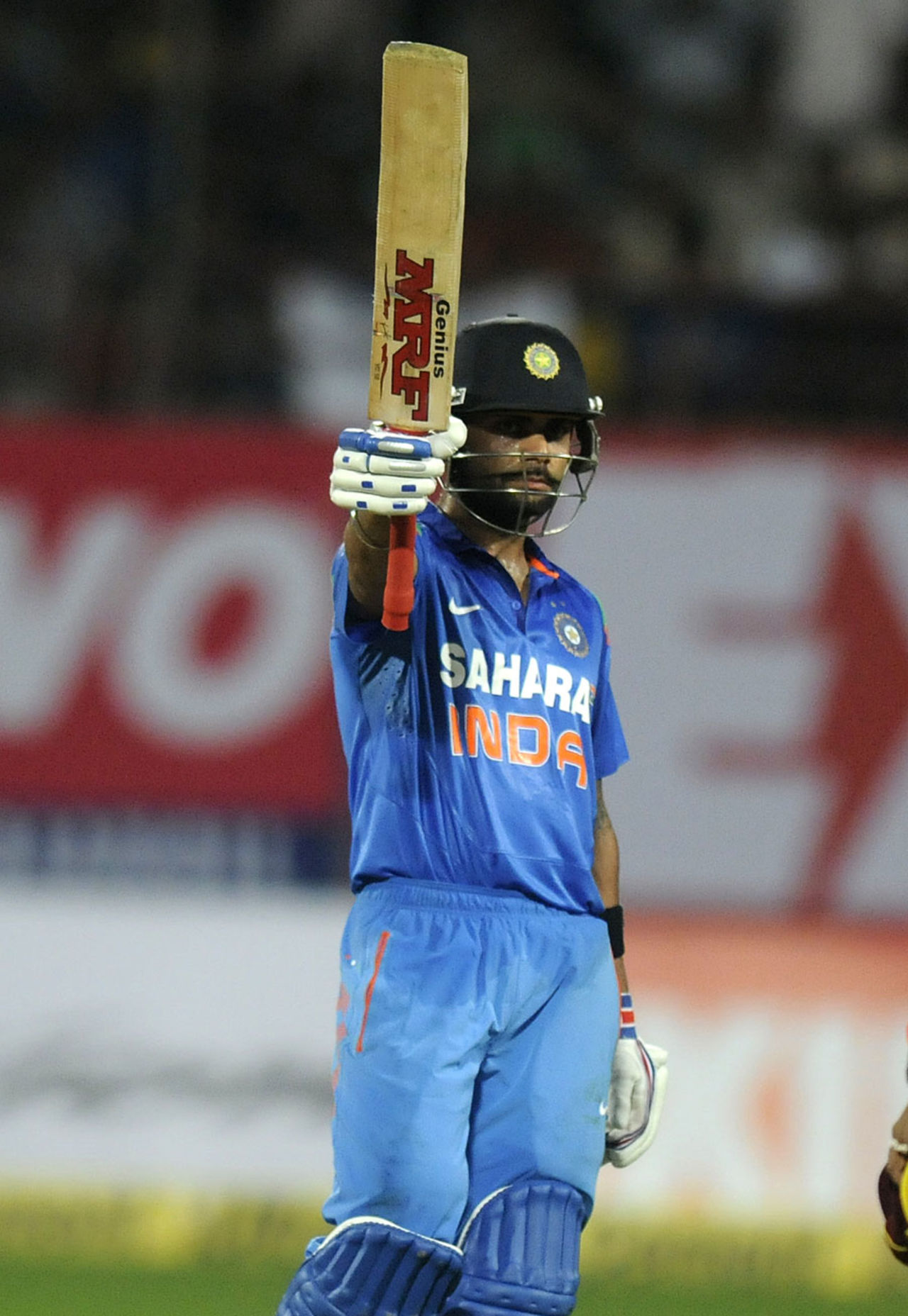 Virat Kohli raises the bat after reaching his fifty, India v West Indies, 1st ODI, Kochi, November 21, 2013