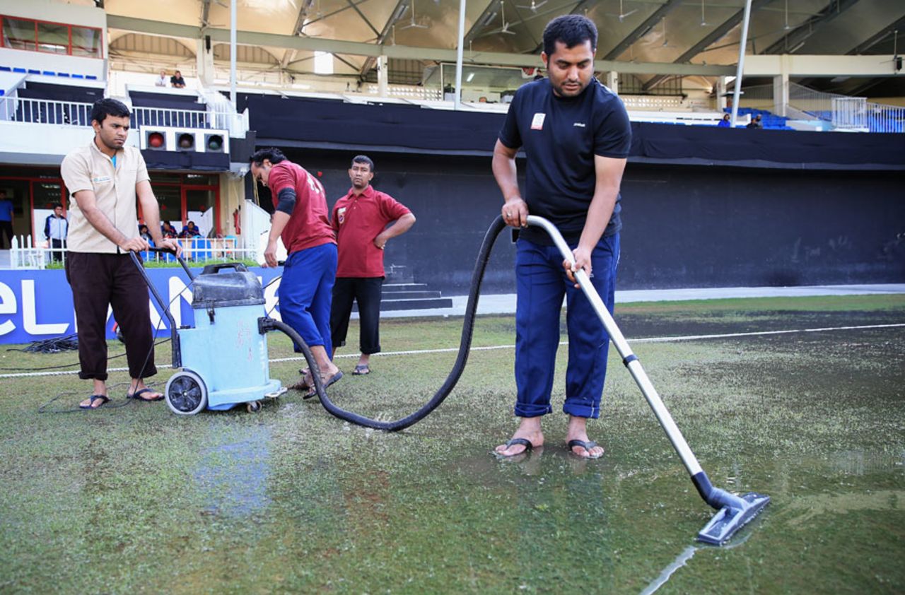 Ground staff try to clear a water-logged outfield, Afghanistan v Nepal, ICC World Twenty20 Qualifier, Group B, Sharjah, November 22, 2013