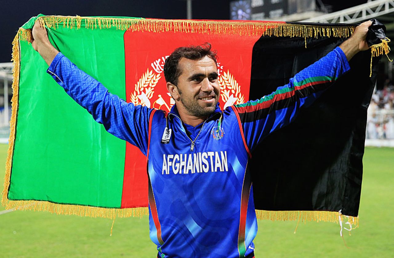 Karim Sadiq holds the Afghanistan flag after beating Nepal, Afghanistan v Nepal, ICC World Twenty20 Qualifiers, Group B, Sharjah, November 22, 2013