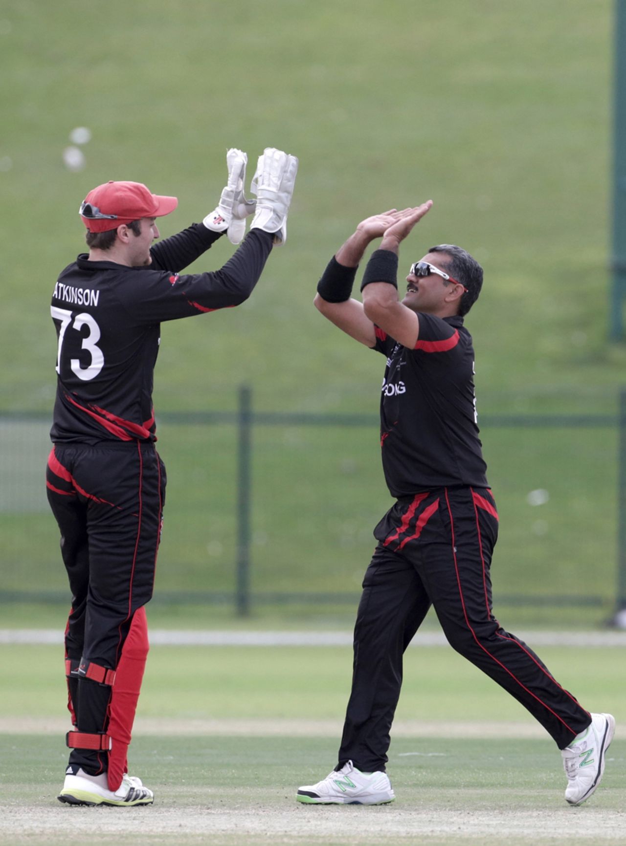 Jamie Atkinson and Munir Dar of Hong Kong celebrate a wicket during ICC World Twenty20 Qualifier between Ireland and Hong Kong at the Zayed Cricket Stadium on November 24, 2013 in Abu Dhabi, United Arab Emirates. (Photo by Graham Crouch-IDI/IDI via Getty Images)
