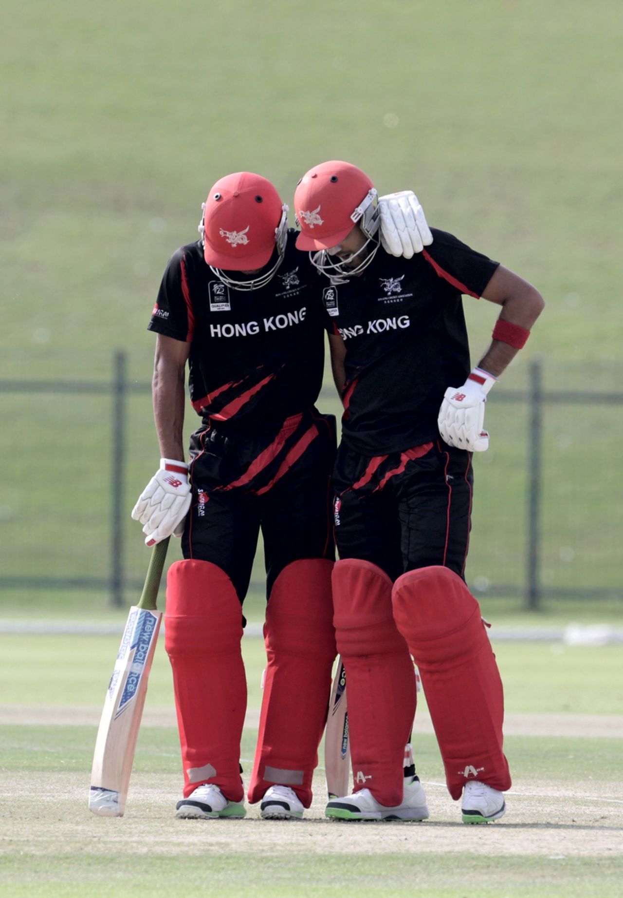 Waqas Barkat (L) and Irfan Ahmed of Hong Kong confer during the Hong Kong v UAE match at the ICC World Twenty20 Qualifiers at the Zayed Cricket Stadium on November 19, 2013 in Abu Dhabi, United Arab Emirates. (Photo by Graham Crouch-IDI/IDI via Getty Images)