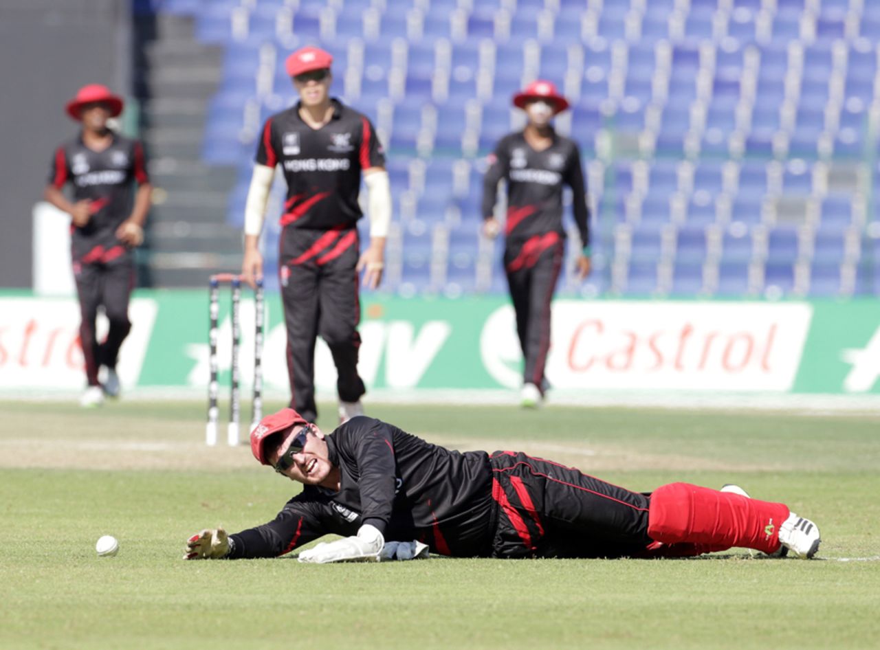 Jamie Atkinson goes down injured after spilling a catch during the Hong Kong v Nepal Quarter Final match 60 at the ICC World Twenty20 Qualifiers at the Zayed Cricket Stadium on November 27, 2013 in Abu Dhabi, United Arab Emirates. (Photo by Graham Crouch-IDI/IDI via Getty Images)