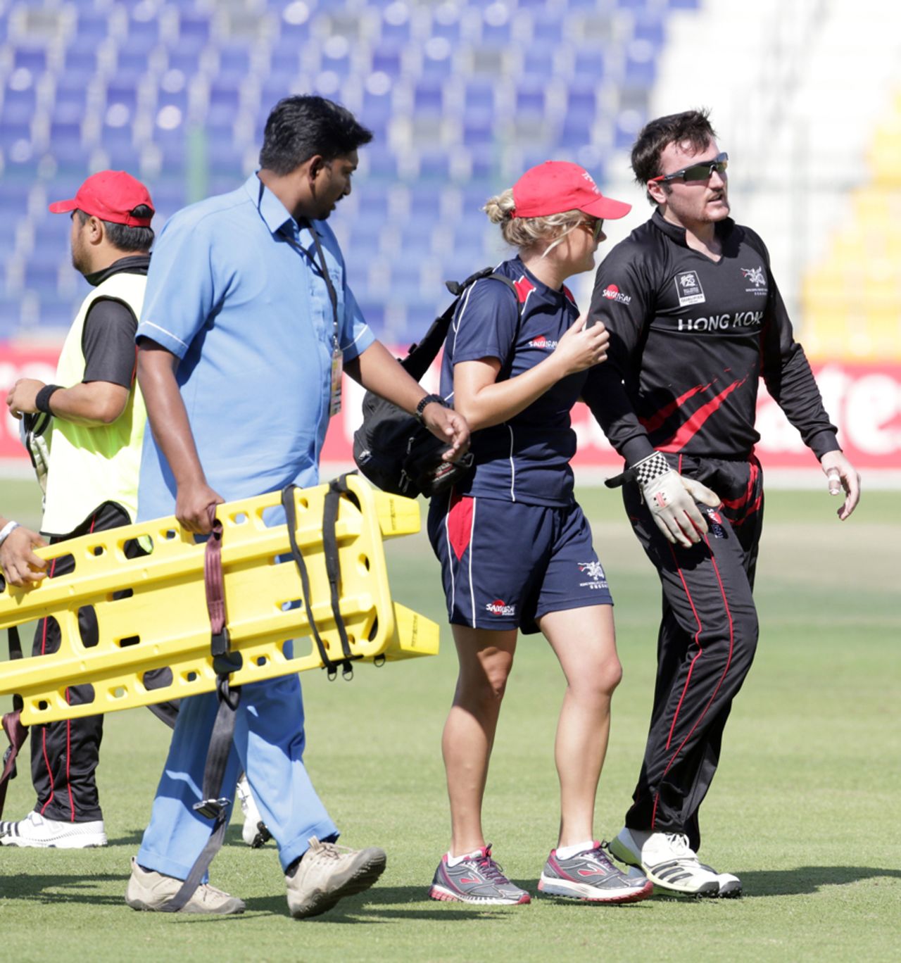 Jamie Atkinson of Hong Kong leaves the field injured after spilling a catch during the Hong Kong v Nepal Quarter Final match 60 at the ICC World Twenty20 Qualifiers at the Zayed Cricket Stadium on November 27, 2013 in Abu Dhabi, United Arab Emirates. (Photo by Graham Crouch-IDI/IDI via Getty Images)
