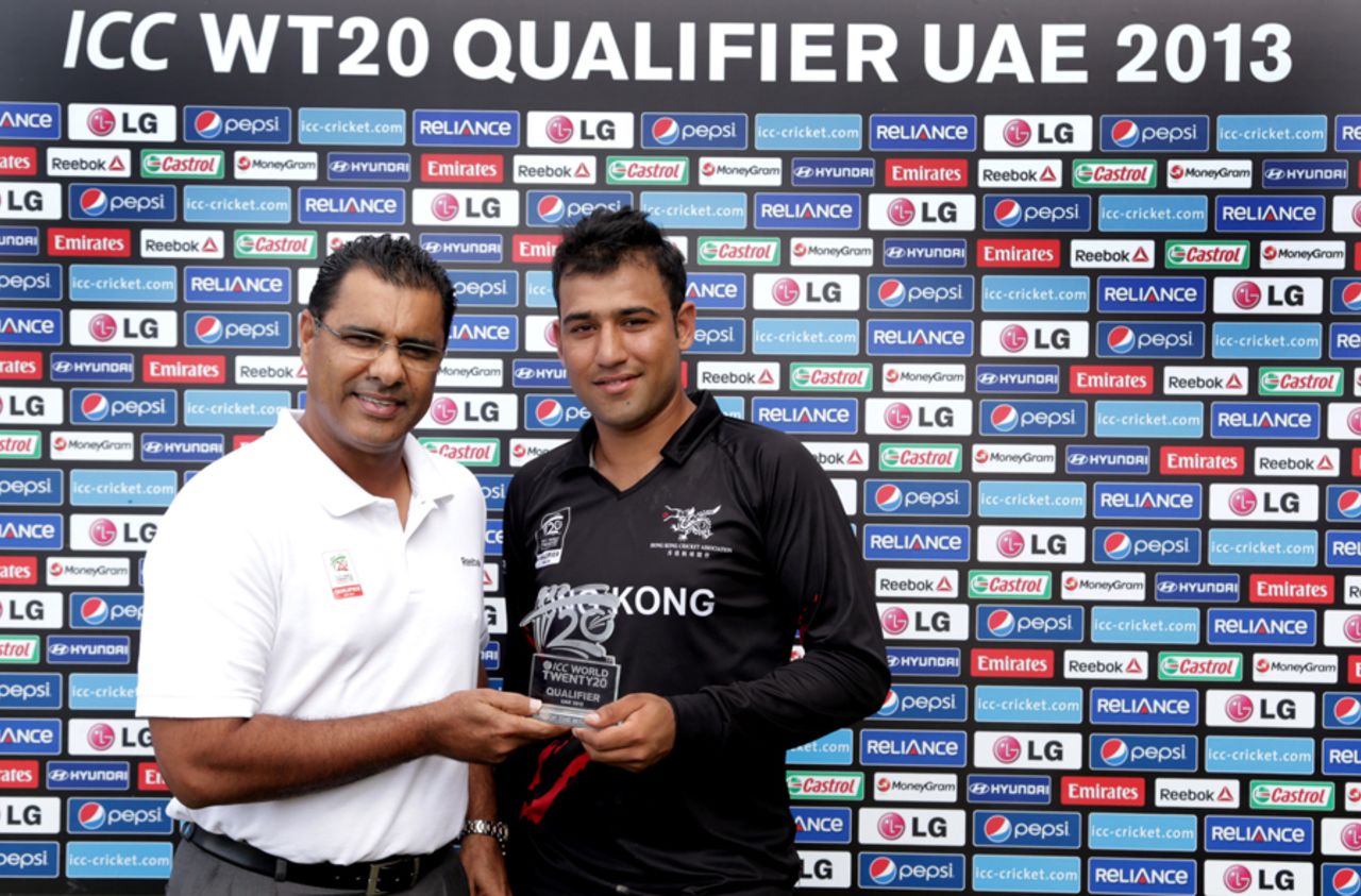Waqar Younis presents Babar Hayat of Hong Kong with the man of the match award after the Papua New Guinea v Hong Kong Qualifying Play-off match at the ICC World Twenty20 Qualifiers at the Zayed Cricket Stadium on November 28, 2013 in Abu Dhabi, United Arab Emirates. (Photo by Graham Crouch-IDI/IDI via Getty Images)