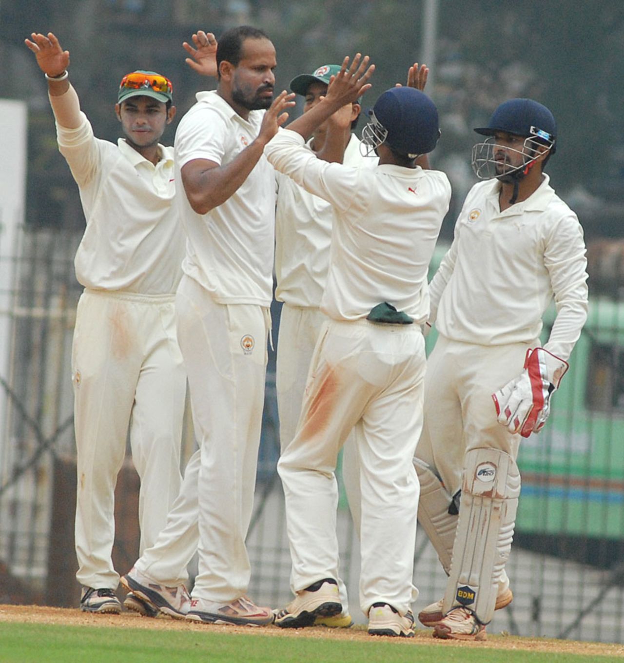 Yusuf Pathan and his Baroda team-mates celebrate a wicket, Tamil Nadu v Baroda, Ranji Trophy, Group B, Chennai, 2nd day, December 7, 2013