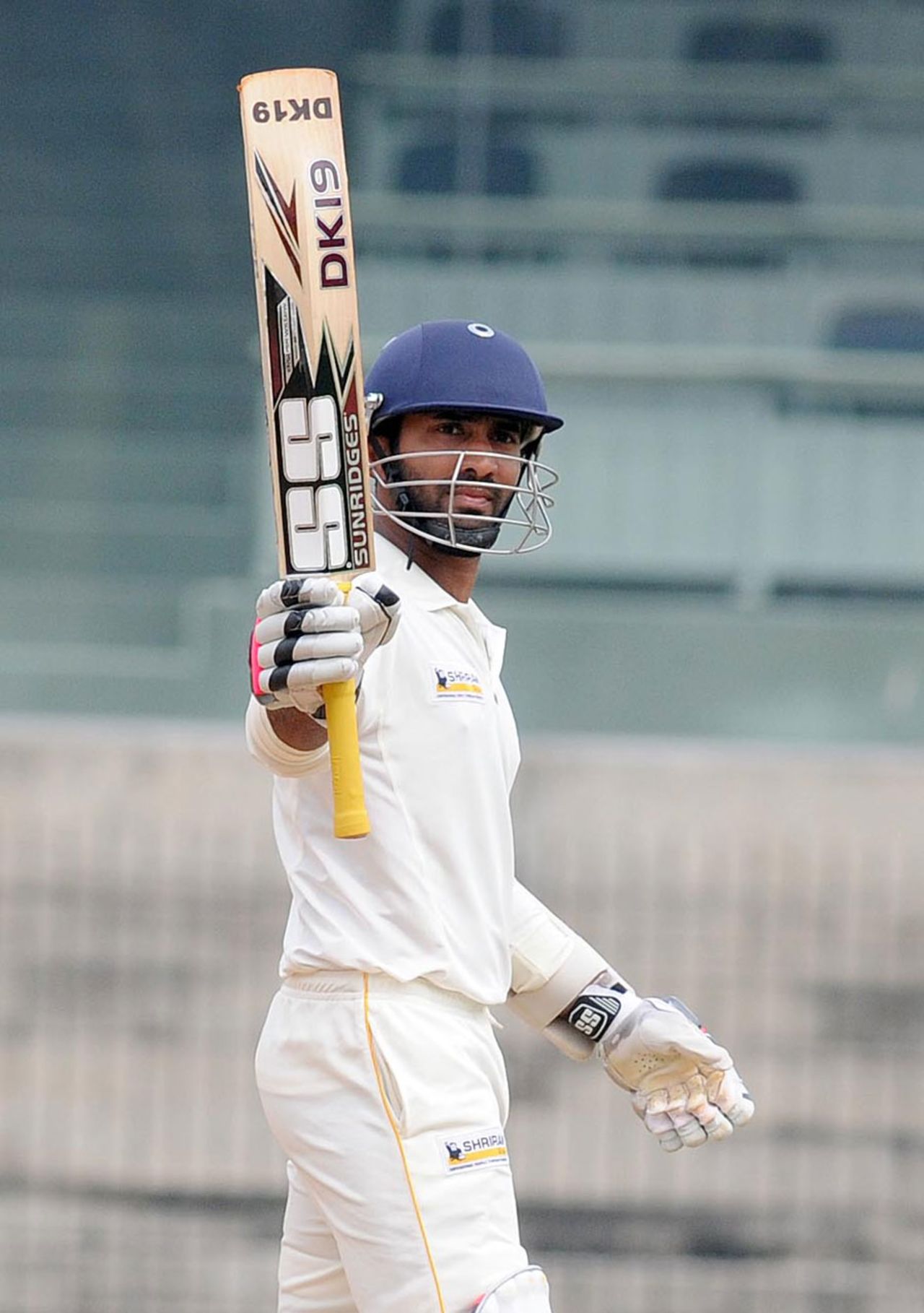 Dinesh Karthik raises his bat after scoring a fifty, Tamil Nadu v Baroda, Ranji Trophy, Group B, Chennai, 3rd day, December 8, 2013
