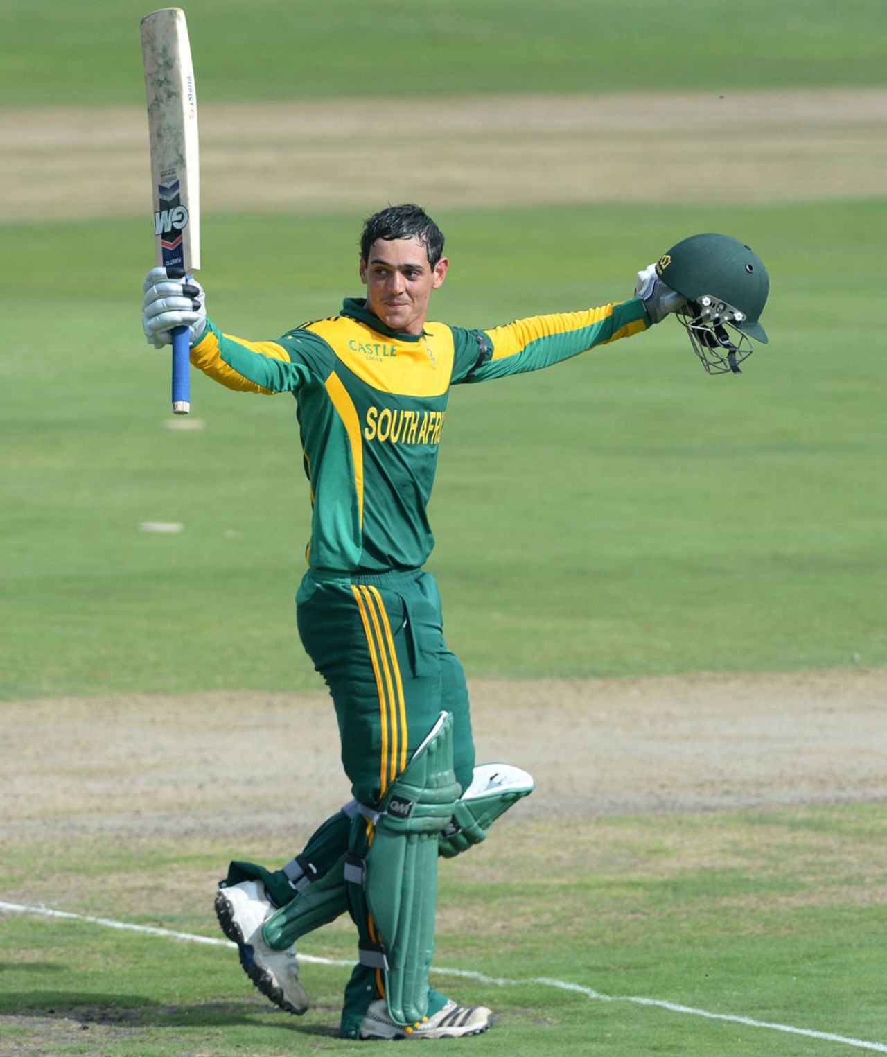 Quinton de Kock raises his bat after scoring his third consecutive hundred, South Africa v India, 3rd ODI, Centurion, December 11, 2013
