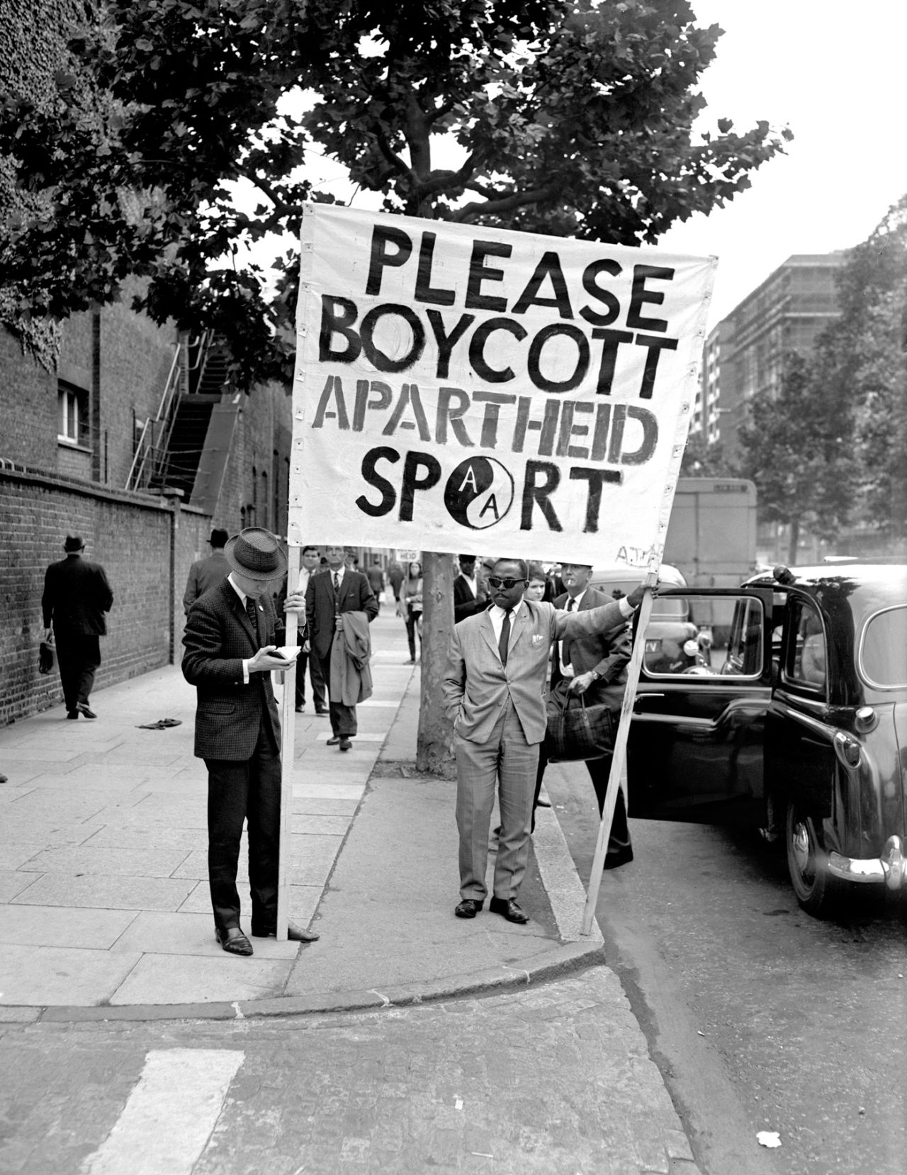 Protests hold up an anti-apartheid banner outside Lord's, England v South Africa, 1st Test, Lords, 1st day, July 22, 1965