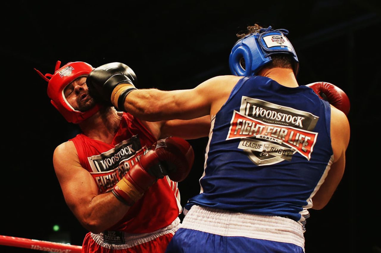 Chris Cairns connects with Simon Doull's jaw at a boxing match, Auckland, December 14, 2013
