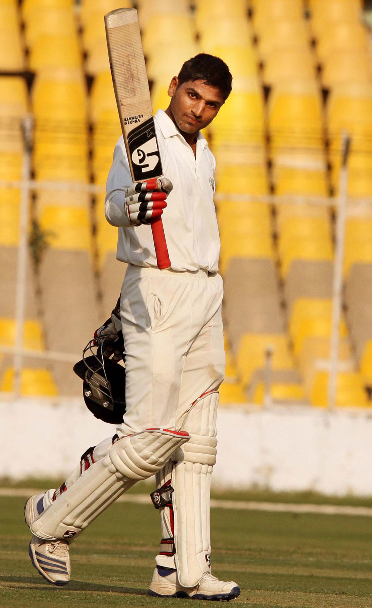 Nitin Saini sneaks a look at the camera after reaching a century, Gujarat v Haryana, Ranji Trophy 2013-14, Group A, 2nd day, Ahmedabad, December 15, 2013