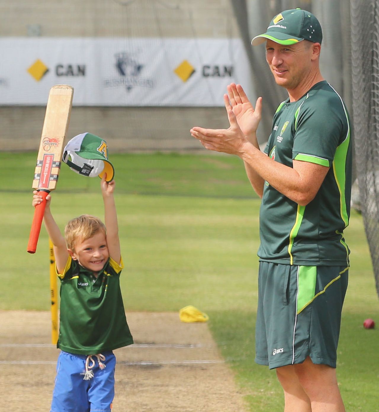 Brad Haddin applauds as his son, Zac, bats in the nets, Melbourne, December 25, 2013