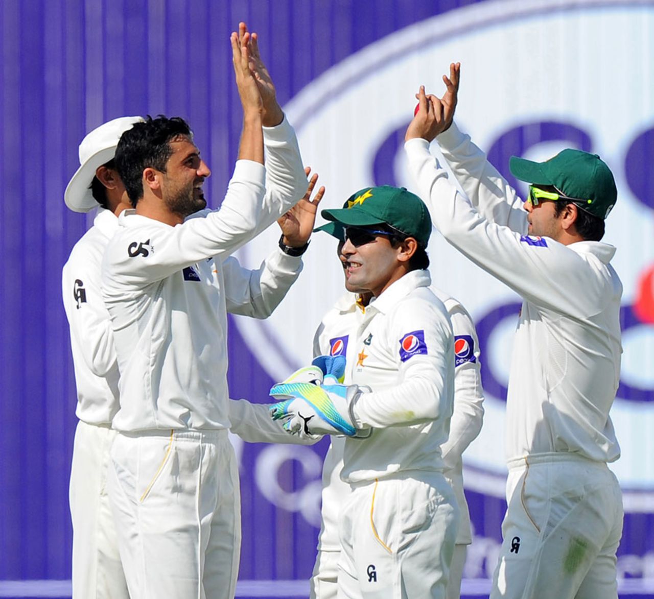 Junaid Khan is congratulated after picking up a wicket, Pakistan v Sri Lanka, 1st Test, Abu Dhabi, 1st day, December 31, 2013