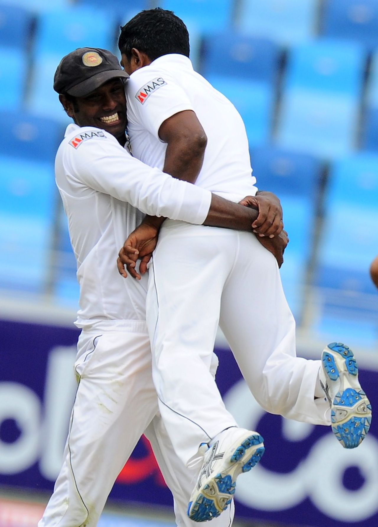 Angelo Mathews lifts Rangana Herath in joy after Misbah-ul-Haq is bowled, Pakistan v Sri Lanka, 2nd Test, Dubai, 4th day, January 11, 2014