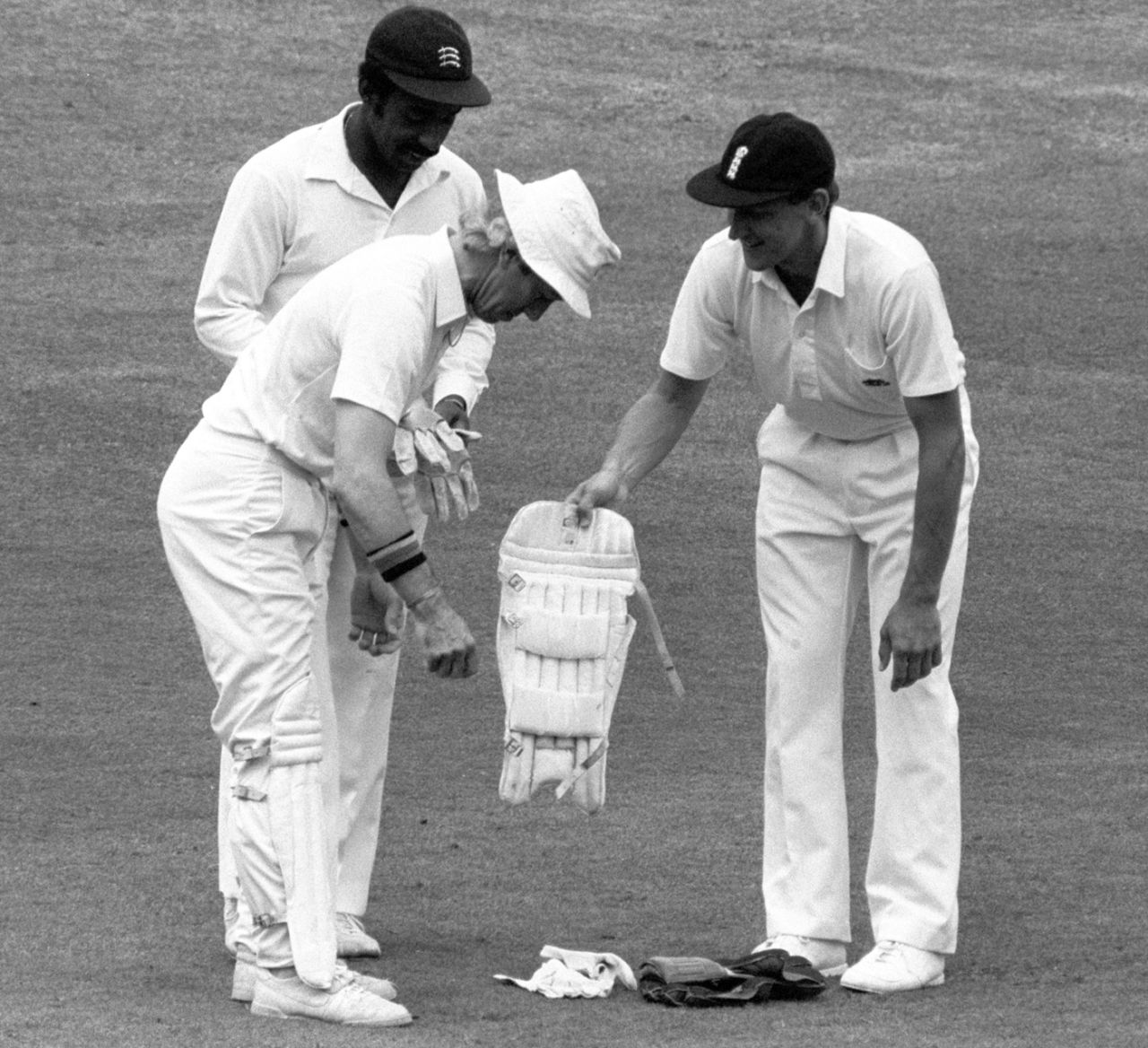 Bill Athey helps substitute keeper Bob Taylor put his pads on while Roland Butcher holds the gloves, England v New Zealand, 1st Test, Lord's, 2nd day, July 25, 1986