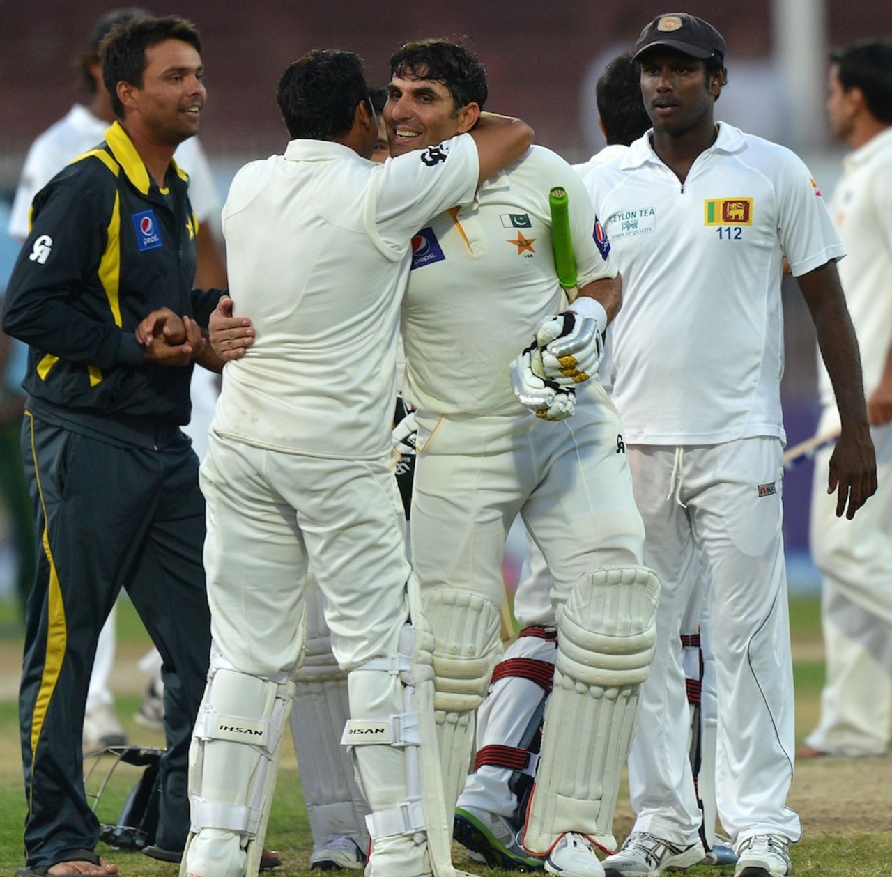 Misbah-ul-Haq is congratulated by team-mates after hitting the winning runs, Pakistan v Sri Lanka, 3rd Test, Sharjah, 5th day, January 20, 2014