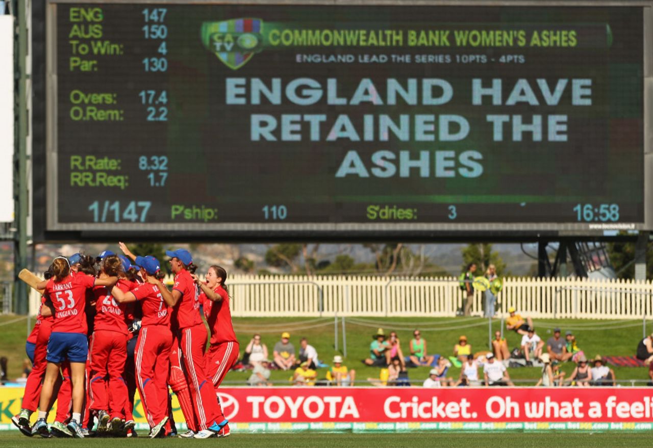 England celebrate as the Hobart scoreboard tells the story, Australia v England, 1st Women's T20I, Hobart, January 29, 2014