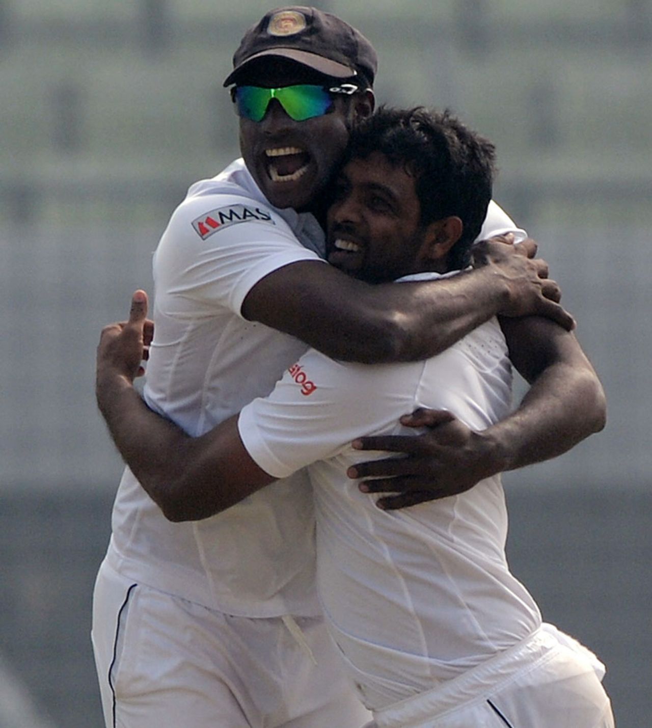 Angelo Mathews embraces Dilruwan Perera after the spinner took a wicket, Bangladesh v Sri Lanka, 1st Test, Mirpur, 4th day, January 30, 2014
